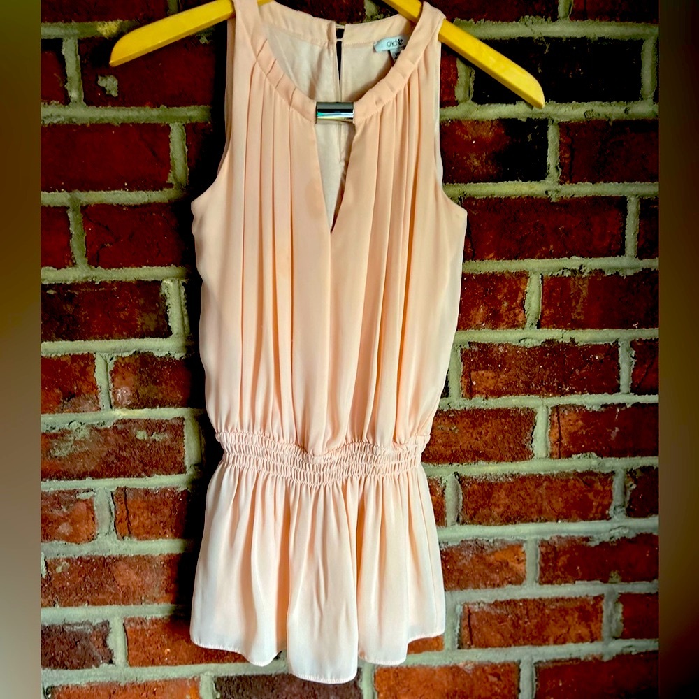 Pale peach sleeveless top with silver metal keyhole cinched waist